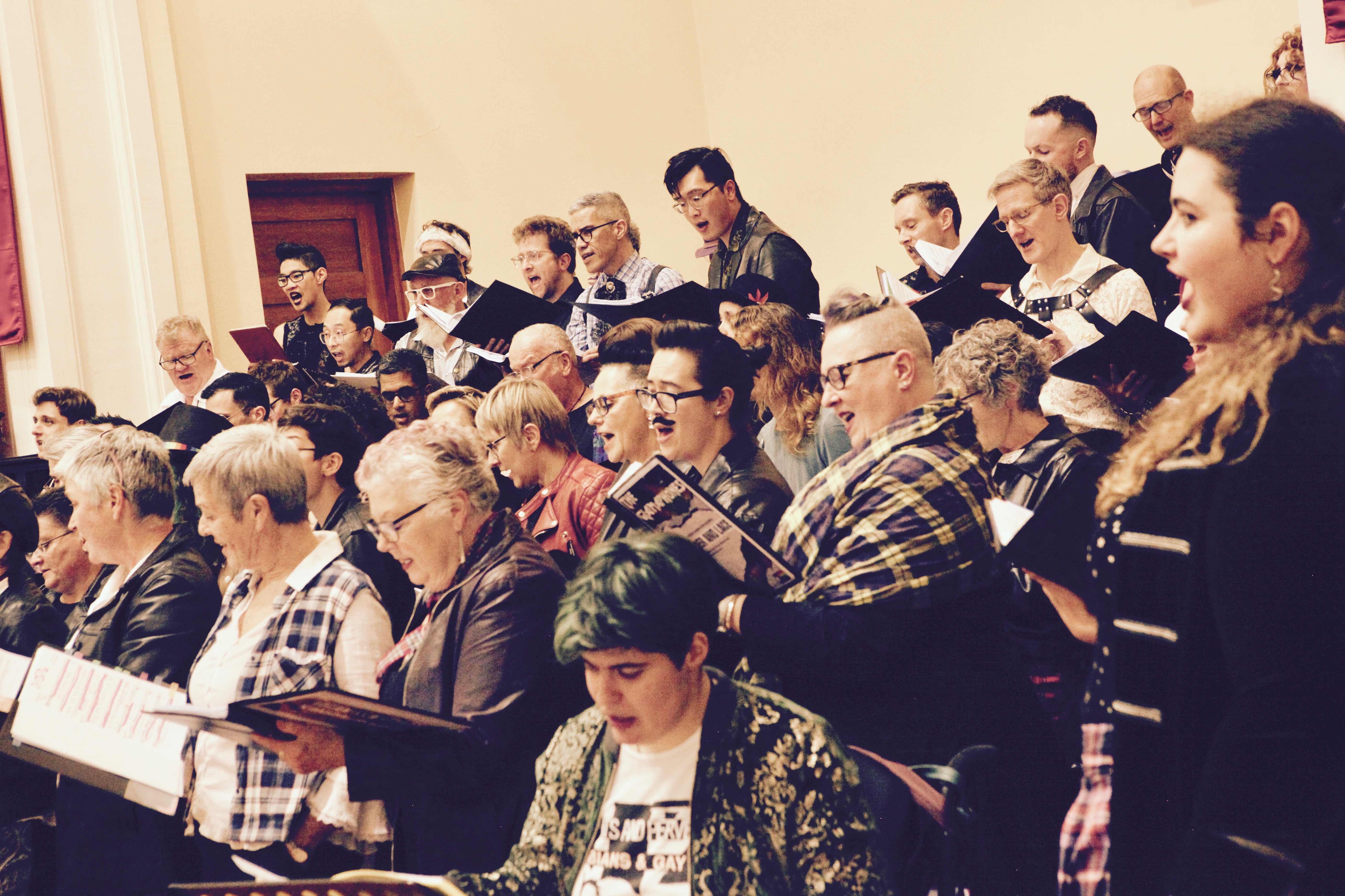 Choir with leather and lace attire performing on stage - view from the Alto side