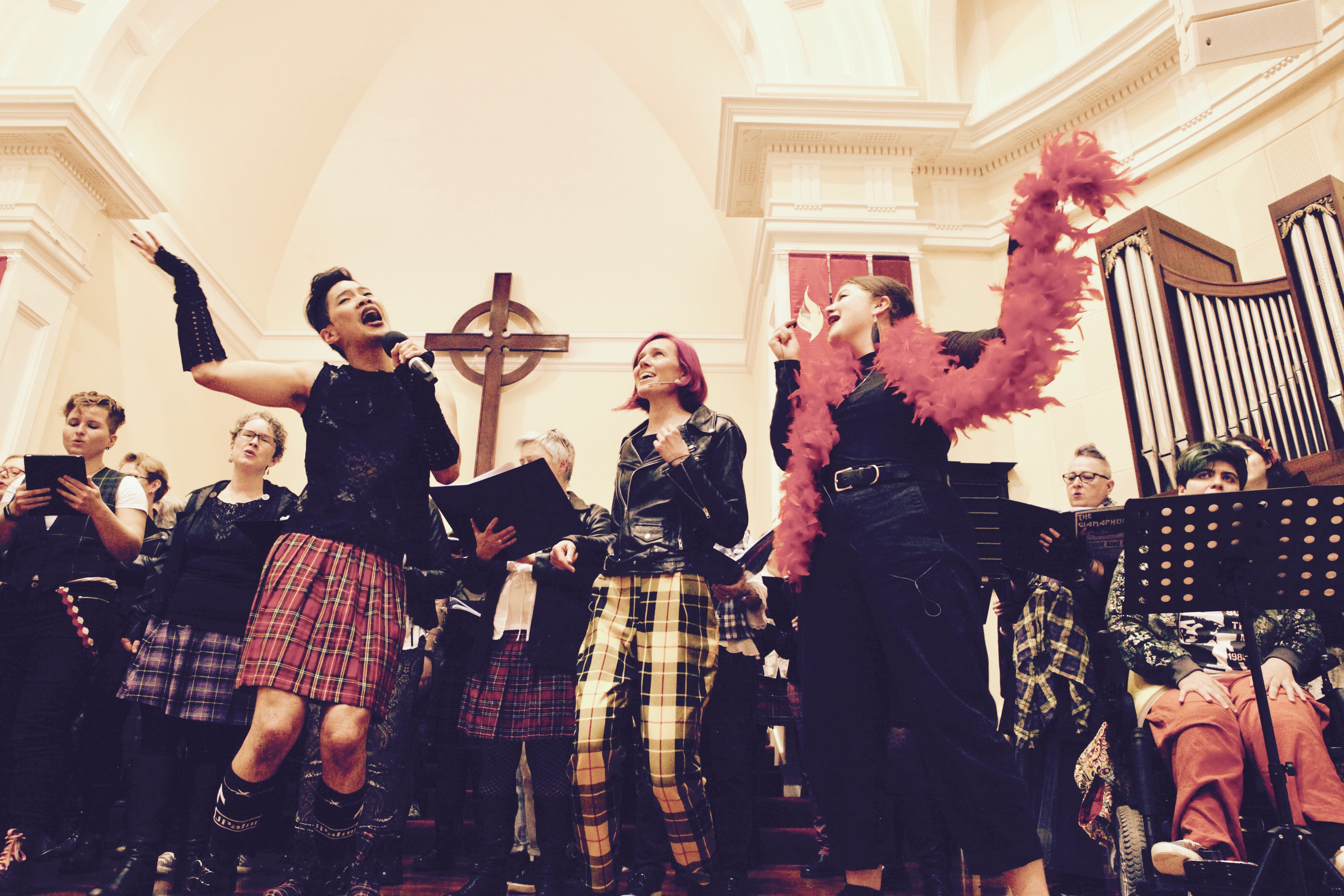 Colorful group of singers performing on stage with leather and lace attire